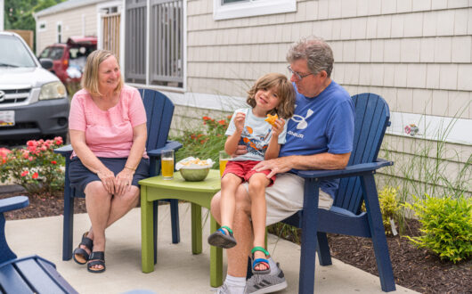 Grandparents with grandchild enjoying private patio