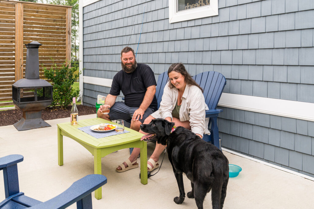 Couple and dog enjoying private patio